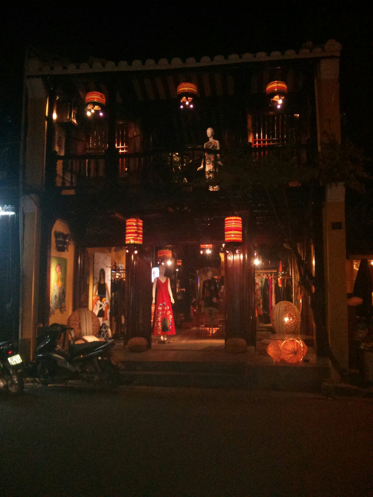 A Chula shopfront in Hoi An lit by lanterns at night