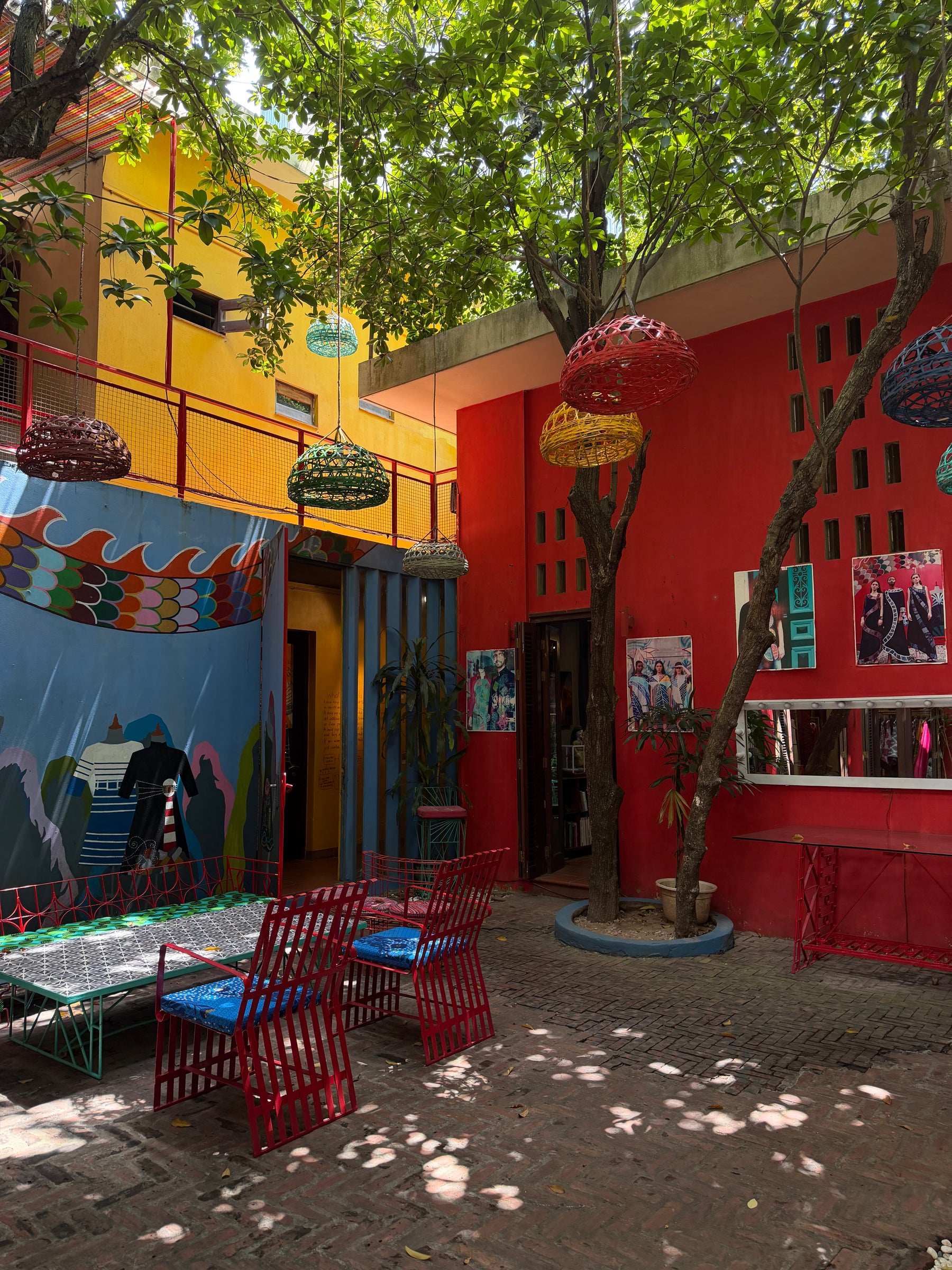 The painted courtyard at Chula House in red and yellow